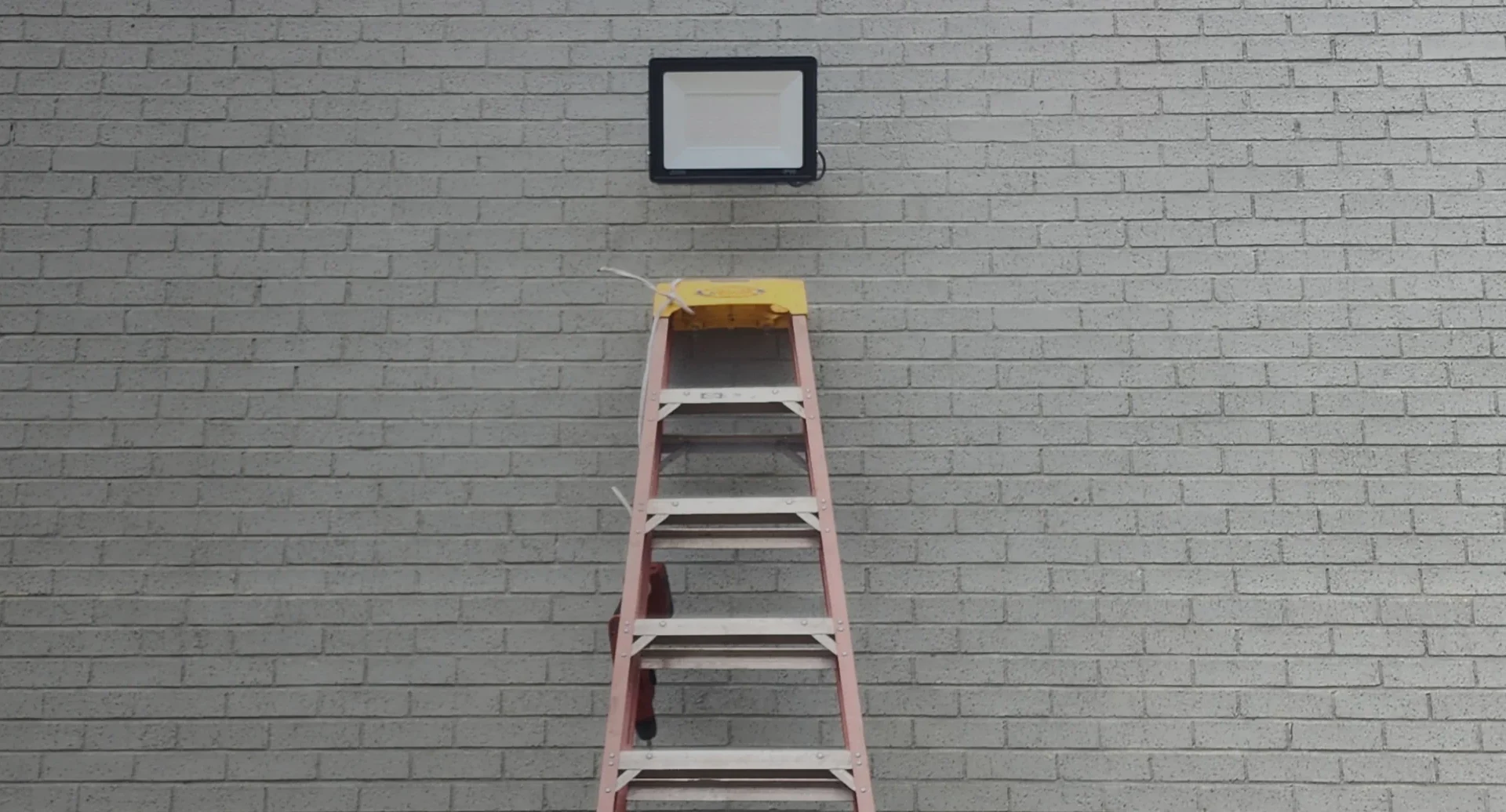 ladder on wall and led lights installed outside